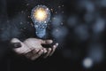 Hand holding the virtual light bulb with brain. Creative new business idea concept Royalty Free Stock Photo