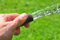 Hand holding a water hose Royalty Free Stock Photo