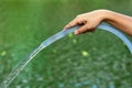 Hand Holding Water Rubber tube for watering