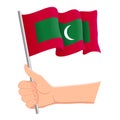 Hand holding and waving the national flag of Maldives. Fans, independence day, patriotic concept. Vector illustration