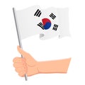 Hand holding and waving the national flag of South Corea. Fans, independence day, patriotic concept. Vector illustration