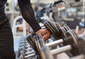 Hand holding weight dumbbell in gym close up arm muscle exercise with dumbbell. Royalty Free Stock Photo