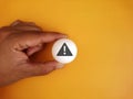 Hand holding white ball table tennis with icon alert on background Royalty Free Stock Photo