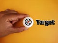 Hand holding white ball table tennis with target board and text Target on background Royalty Free Stock Photo