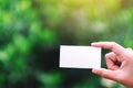 A hand holding a white blank business card Royalty Free Stock Photo