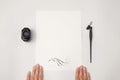 Hand holding white blank paper sheet mockup