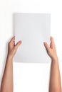 Hand holding white blank paper sheet mockup, isolated. Arm hold clear brochure template mock up. Royalty Free Stock Photo