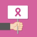 Hand holding white board. Pink ribbon awareness symbol. Breast cancer month. Concept of protest. Vector illustration, flat style Royalty Free Stock Photo
