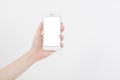 Hand holding white cellphone isolated on white clipping path inside. Online shopping. Top view. Mock up. Copy space. Template.Blan Royalty Free Stock Photo