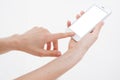 Hand holding white cellphone isolated on white clipping path inside. Online shopping. Top view. Mock up. Copy space. Template.Blan Royalty Free Stock Photo