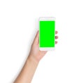 Hand holding white mobile smart phone with blank green screen isolated on white background with clipping path on green screen Royalty Free Stock Photo