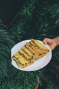 Hand holding white plate Homemade High fiber natural health food Sliced rye bread on cutting board. Whole grain rye bread with see Royalty Free Stock Photo