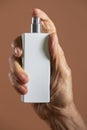 Hand holding a white refillable spray bottle Royalty Free Stock Photo