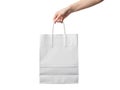 Hand holding a white shopping bag isolated on white background Royalty Free Stock Photo