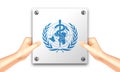 Hand holding a white signage of World Health Organization for illustrative editorial use. The WHO is a specialized agency of the