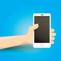 Hand holding white smart phone on blue background. Royalty Free Stock Photo