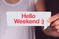Hand holding white talk bubble and showing hello weekend wording