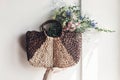hand holding wildflowers in wicker bag at rustic window. colorful flowers in brown basket in sunlight, space for text. rural Royalty Free Stock Photo