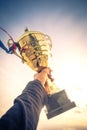 Hand holding winner trophy Royalty Free Stock Photo