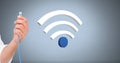 Hand holding wire connection with wi-fi icon