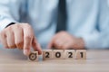 Hand holding wood cubes with New year 2021 and goal or target icon. concept of New year Business goals and vision Royalty Free Stock Photo