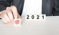 Hand holding wood cubes with New year 2021 and goal or target icon. concept of New year Business goals and vision Royalty Free Stock Photo