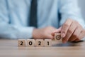 Hand holding wood cubes with New year 2021 and goal or target icon. concept of New year Business goals and vision Royalty Free Stock Photo