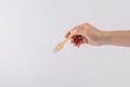 hand holding wood fork isolated on white background.