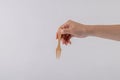 hand holding wood fork isolated on white background.