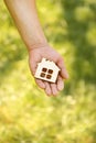 Hand holding a wood house