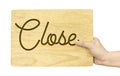 Hand holding wood plate with Close word isolated on white background, Shop sign design, Clipping path on object