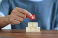 Hand holding wooden block and icon healthcare medical on table, Life insurance of people, Health insurance concept