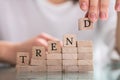 Hand Holding Wooden Block From Word Trend Royalty Free Stock Photo