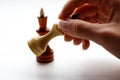 Hand holding wooden chess set on white background. Chess. Black Royalty Free Stock Photo