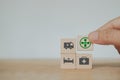 Hand holding wooden cube block with safety first icon , for work safety, caution work hazards, danger surveillance campaign, zero