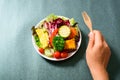 Hand holding wooden fork and eating salad Royalty Free Stock Photo