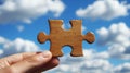 Hand Holding Wooden Jigsaw Puzzle Piece, Blue Sky, Clouds Background, Concept of Solution, Strategy Royalty Free Stock Photo