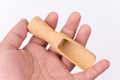 Hand holding wooden measuring spoon Royalty Free Stock Photo