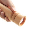 Hand holding wooden pepper grinder