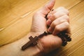 Hand holding wooden rosary beads Royalty Free Stock Photo