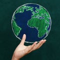 Hand holding world on chalkboard Royalty Free Stock Photo