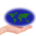 Hand holding a world map with green land masses