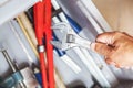 Hand holding wrench over tool box closeup Royalty Free Stock Photo