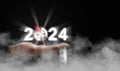 A hand holding the year 2024 with dart, and target above the cloud. Starting new year, business, project, path, goal, or life.