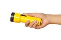 Hand holding yellow flashlight over white background Royalty Free Stock Photo