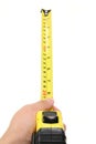 Hand holding yellow measuring tape