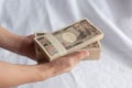 Hand holding 10000 yen bills isolated on white background. Royalty Free Stock Photo