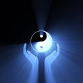 Hand holding Yin Yang sign light flare Royalty Free Stock Photo