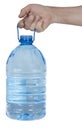 The hand holds aloft the five-liter plastic bottle with water