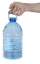 The hand holds aloft the five-liter plastic bottle with water Royalty Free Stock Photo